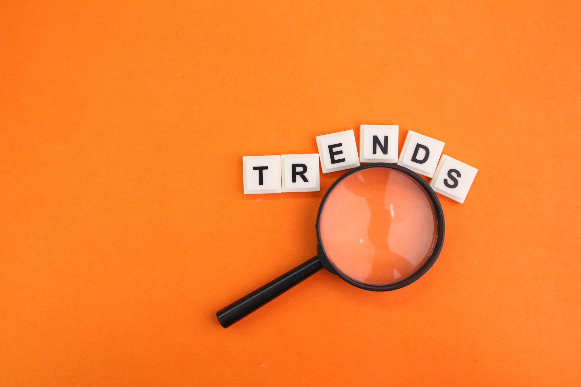 A magnifying glass and letters spelling 'trends' | Featured Image for the Market Research Trends blog.